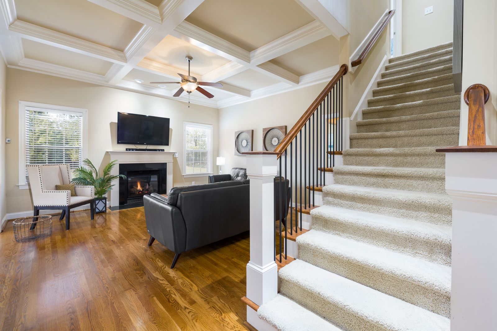 Bright living room with a fireplace and staircase for an in home visit