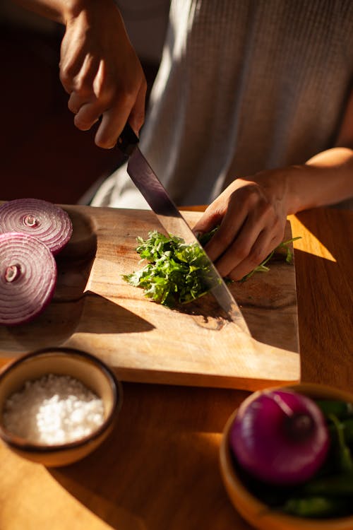 A Person Slicing Cilantro