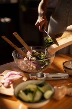 Person preparing traditional Mexican dish with fresh ingredients in a sunlit kitchen.