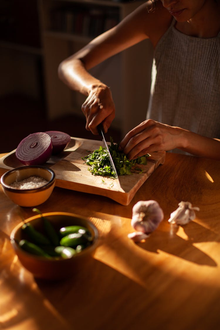 A Woman Chopping Cilantro