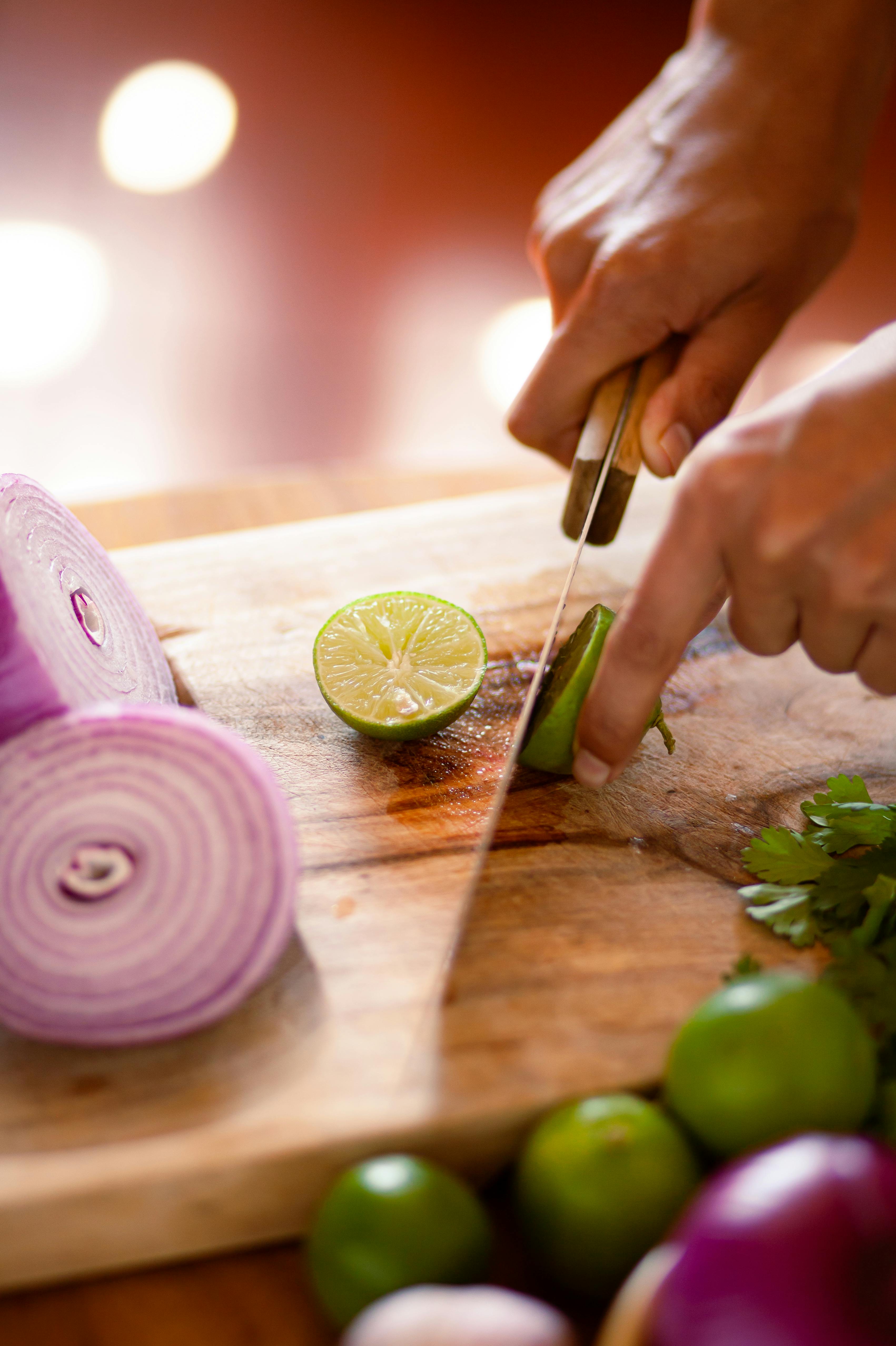 a person slicing a lime