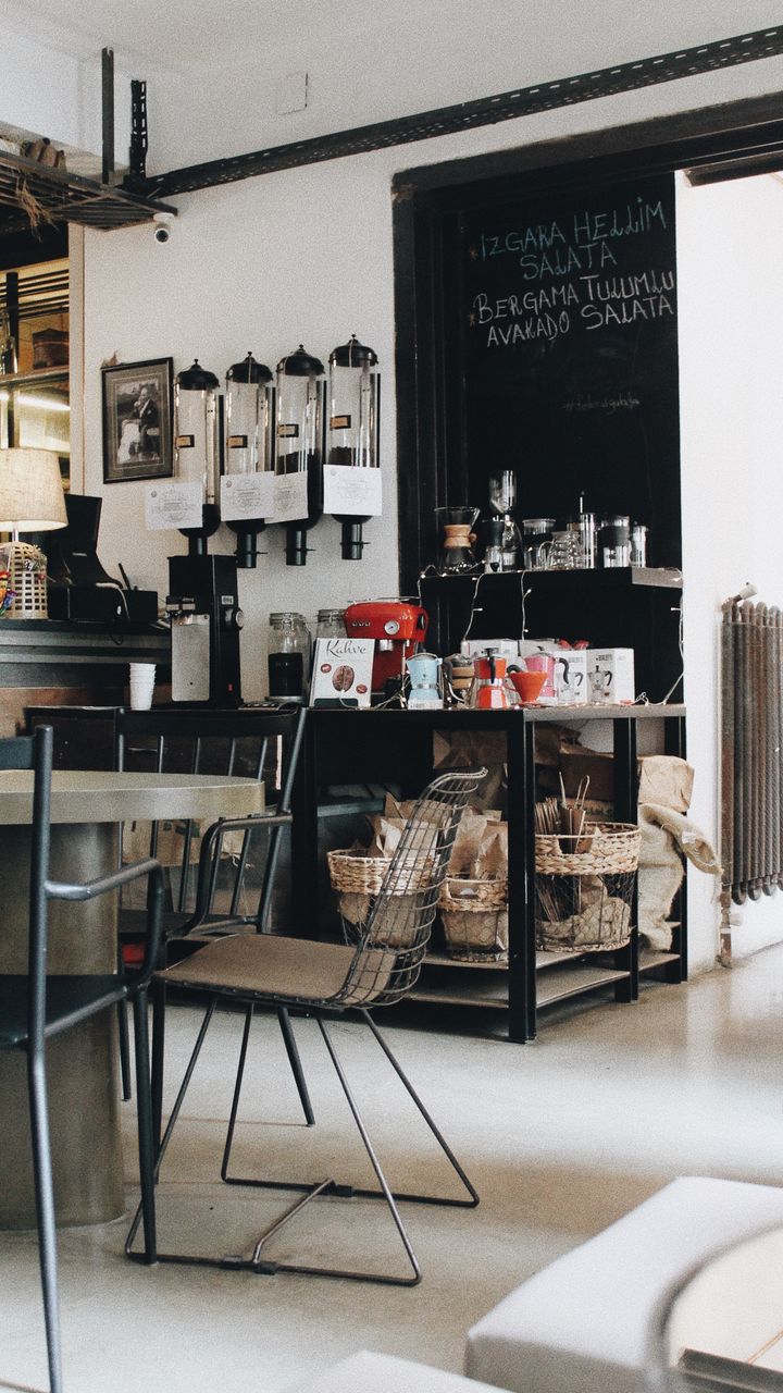 black industrial pipe shelf in a kitchen corner used as a modern small coffee bar