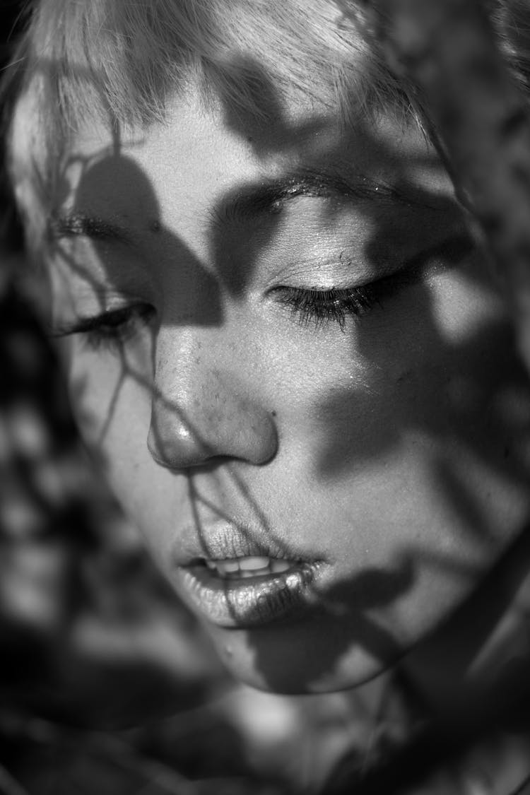 Crop Gentle Woman With Leaf Shadows On Face