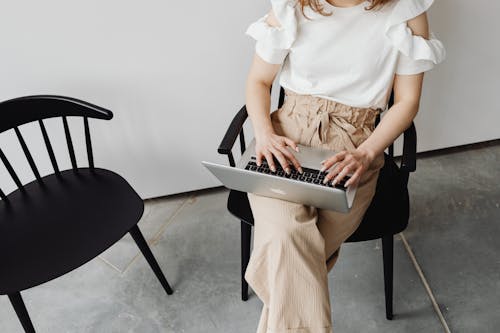 A Woman Typing on her Laptop
