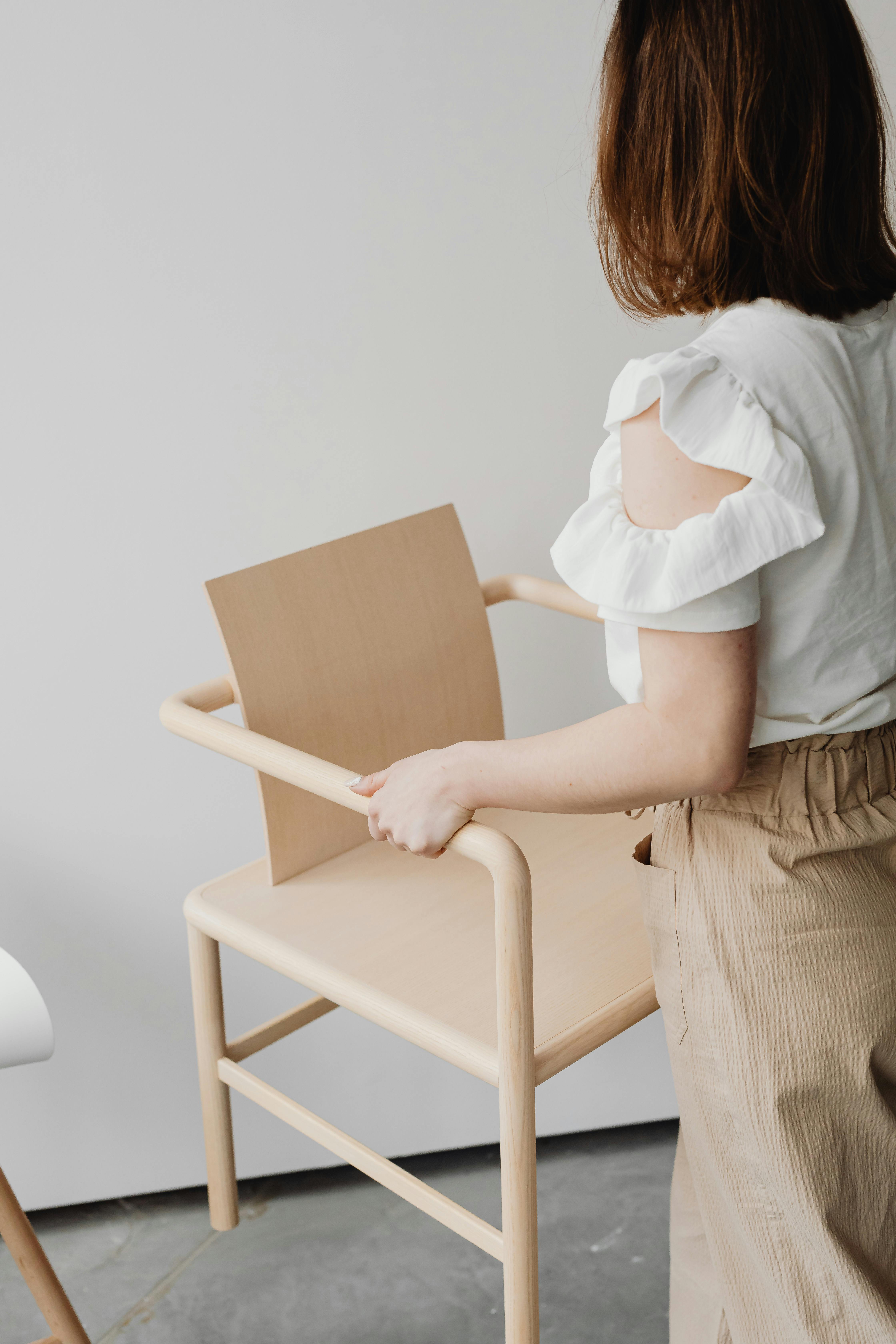Woman Holding Chair · Free Stock Photo