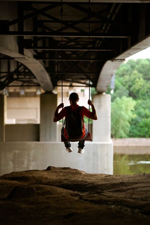 Free A person swings under a bridge in Minneapolis, capturing a serene outdoor moment. Stock Photo