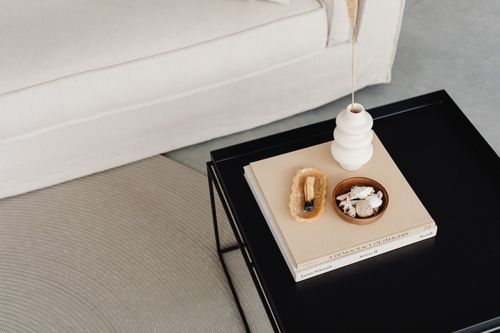 Free Stylish black center table with decorative elements in a modern living room. Stock Photo