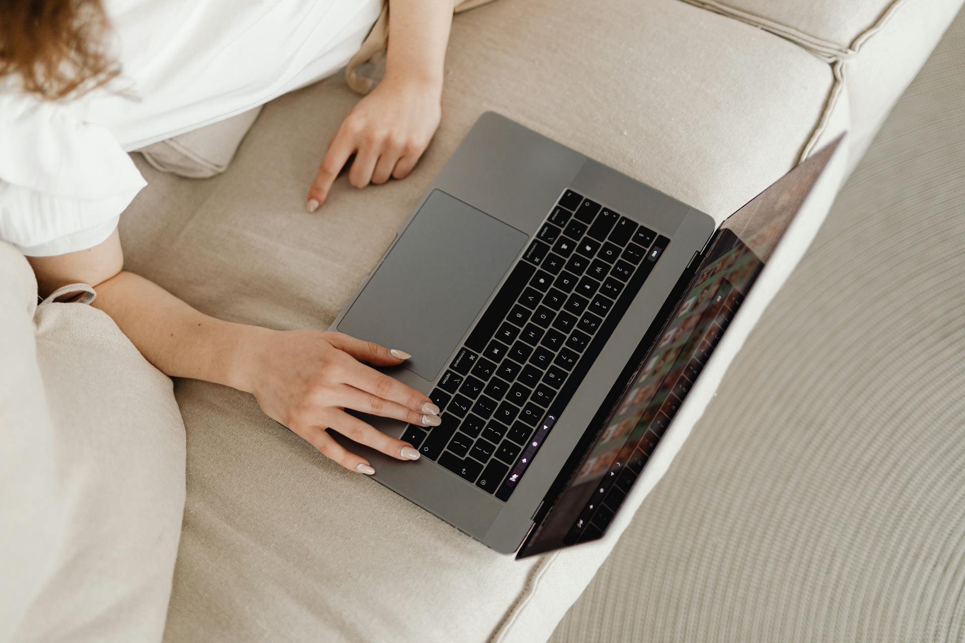A Person using a Laptop while on the Couch
