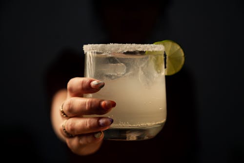 Free A Person Holding a Glass Cup with Margarita Stock Photo