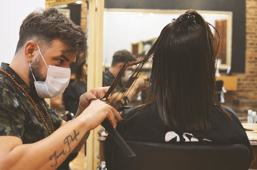 Free Barber Cutting the Long Hair of a Person Stock Photo