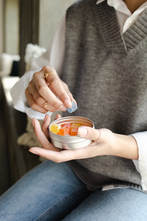 Free A Person Holding a Can of Gummy Candy Stock Photo