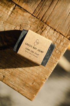 High-quality handcrafted CBD soap with vanilla oak scent on a wooden surface.