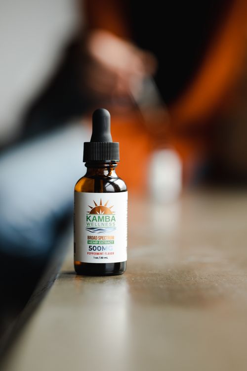 Free Focused image of CBD oil bottle with dropper on blurred background. Ideal for wellness themes. Stock Photo
