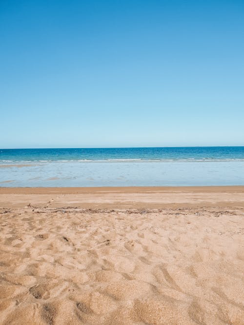 Free Photo of Brown Sand Near the Sea Stock Photo
