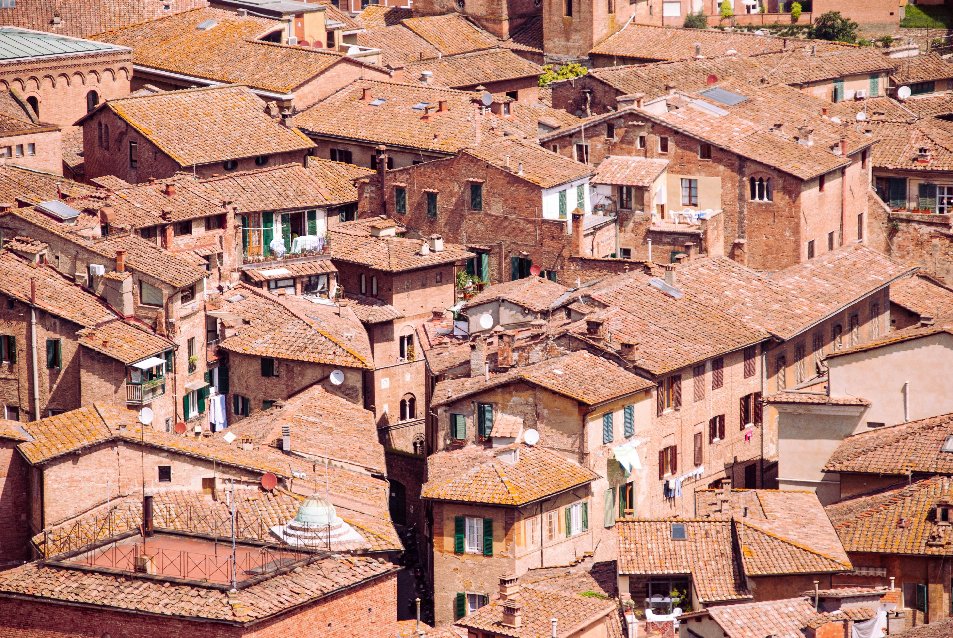 A captivating aerial view of Siena's historic tile rooftops in Tuscany, Italy.