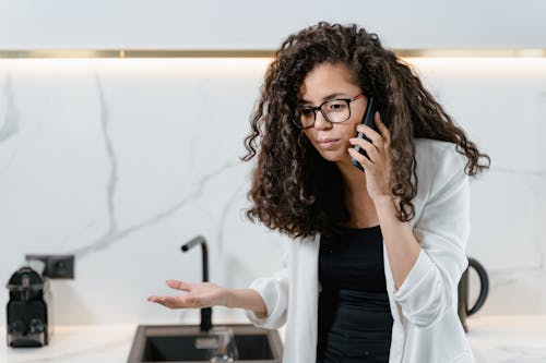 Close Up Photo of Woman Talking on the Phone