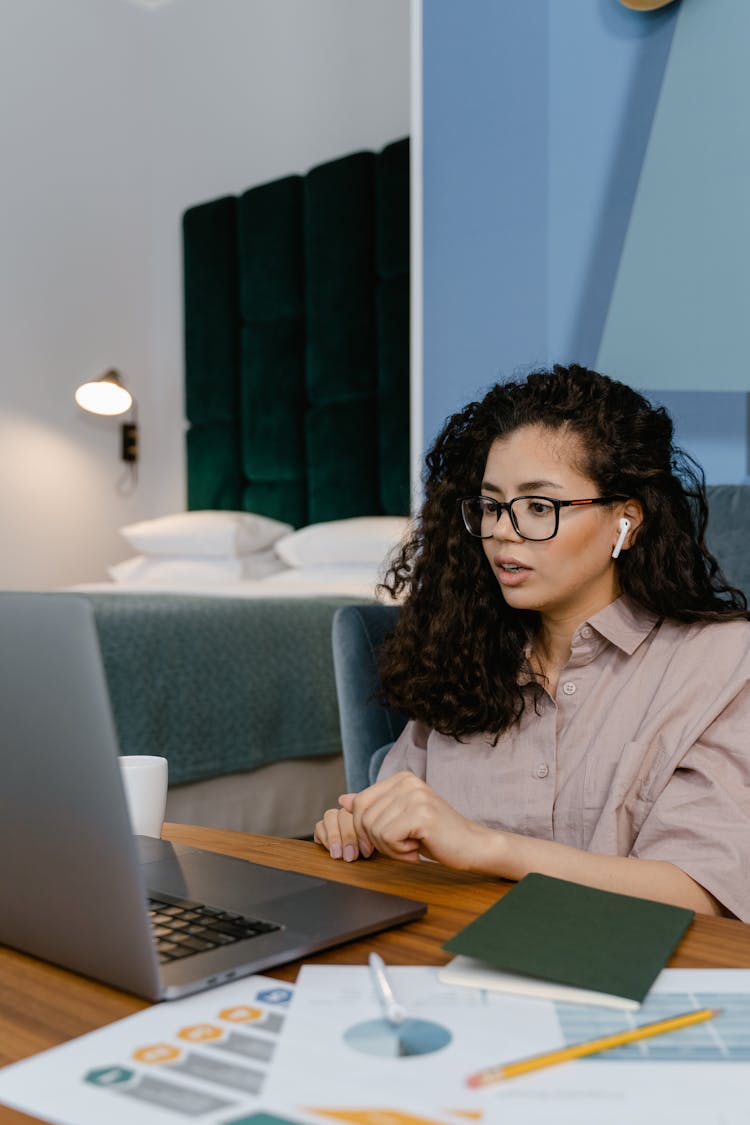 Woman Using A Laptop Inside The Bedroom