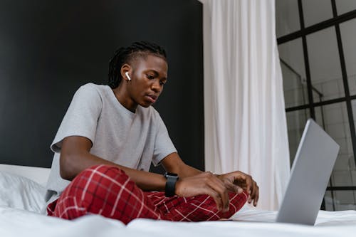 A Man in Pajamas Working on Laptop