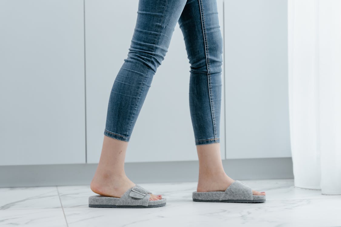Free A Person in Blue Denim Jeans and Grays Slippers
 Stock Photo