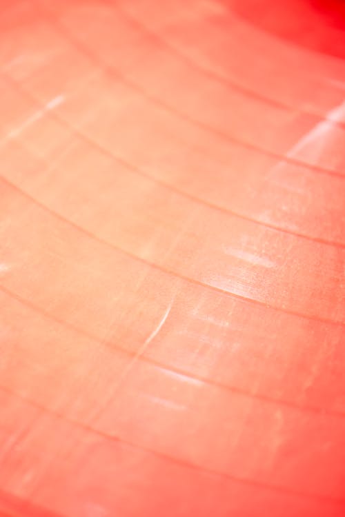 A Close-up Photo of an Orange Vinyl Record