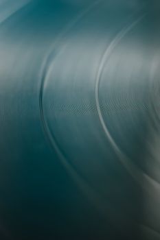 Blurred close-up of a vinyl record's grooves, creating a soothing abstract pattern.