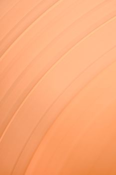 Abstract minimalist image featuring smooth orange curves and lines, ideal for backgrounds or designs.