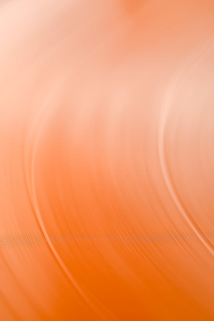 An Orange Vinyl Record Spinning In Close-up Shot