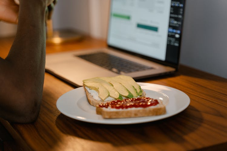 Bread Slices With Avocado And Ketchup On White Plate