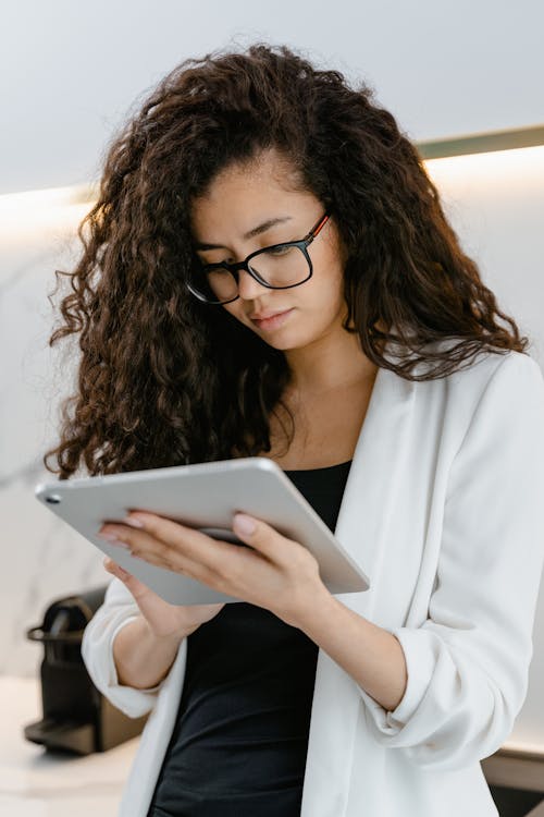 Close Up Photo of Woman Using a Tablet