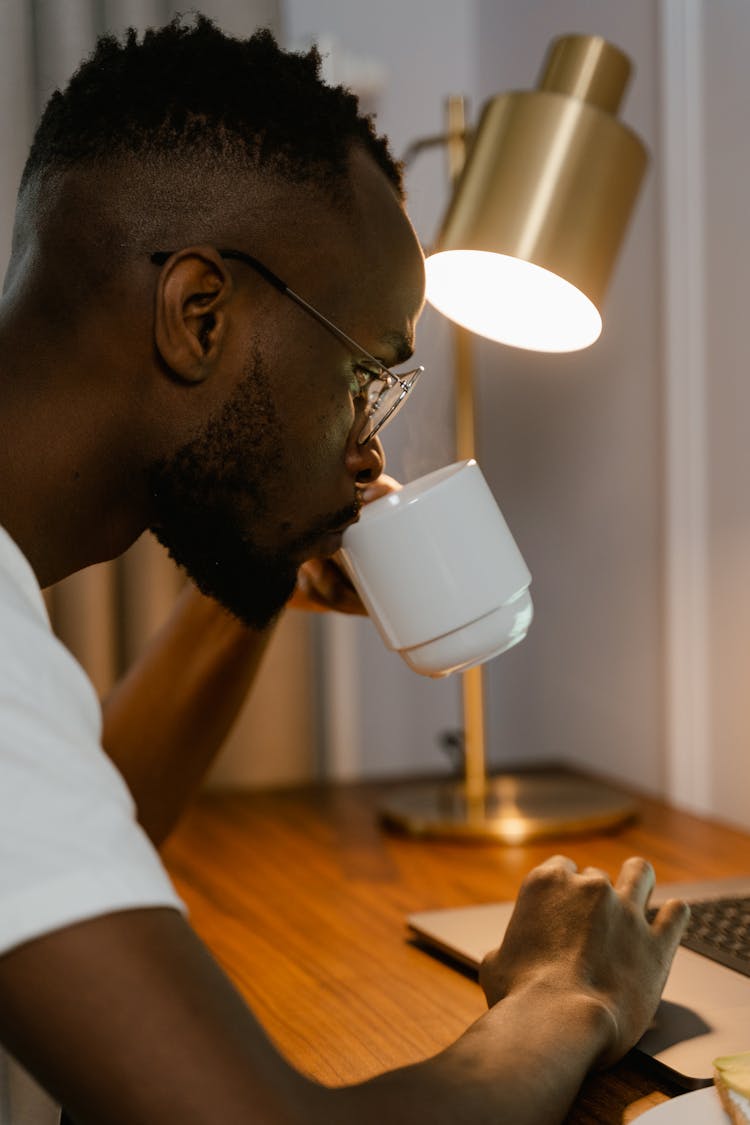 Close Up Photo Of Man Drinking From A Cup