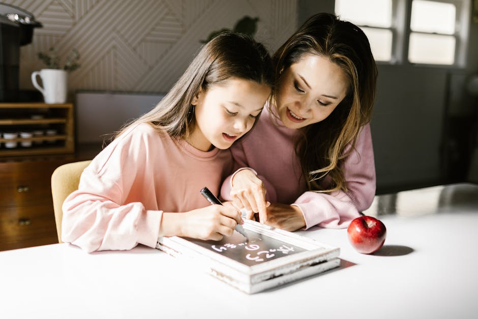 A mother and daughter collaborate on a school project at the kitchen table, fostering learning and creativity.