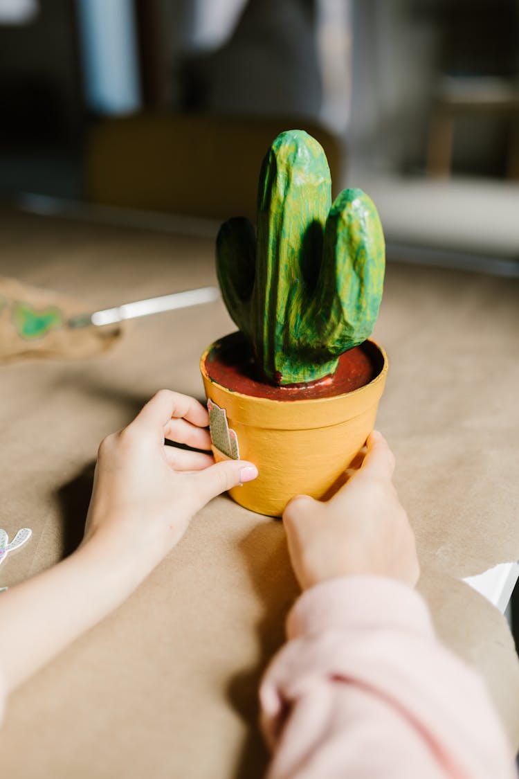 Close-up Photo Of A Cactus Artwork Held By A Person 