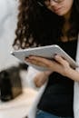 Close Up Photo of a Woman Holding a Tablet