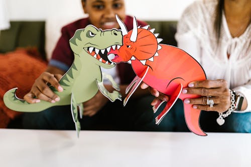 A Mother and Son Playing with Paper Dinosaurs