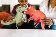 A Mother and Son Playing with Paper Dinosaurs