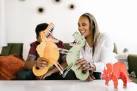 A Mother and Son Playing with Dinosaurs