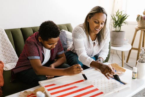 Free A Mother Helping Her Son with a School Project Stock Photo