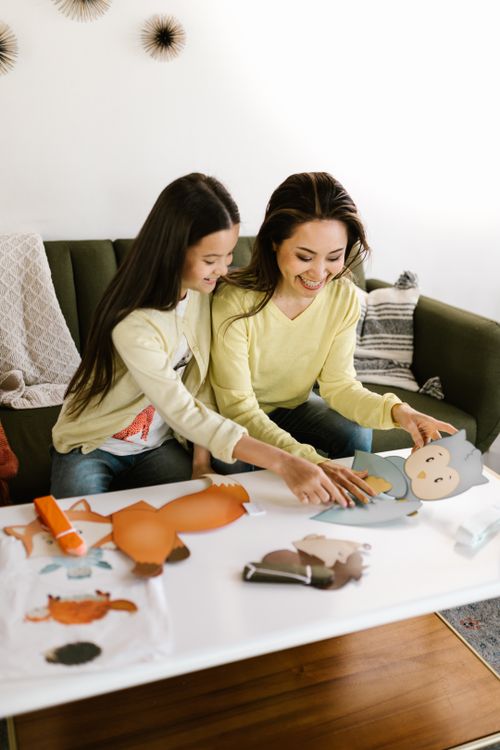 Free A mother and daughter enjoy a fun craft session together at home, fostering creativity. Stock Photo