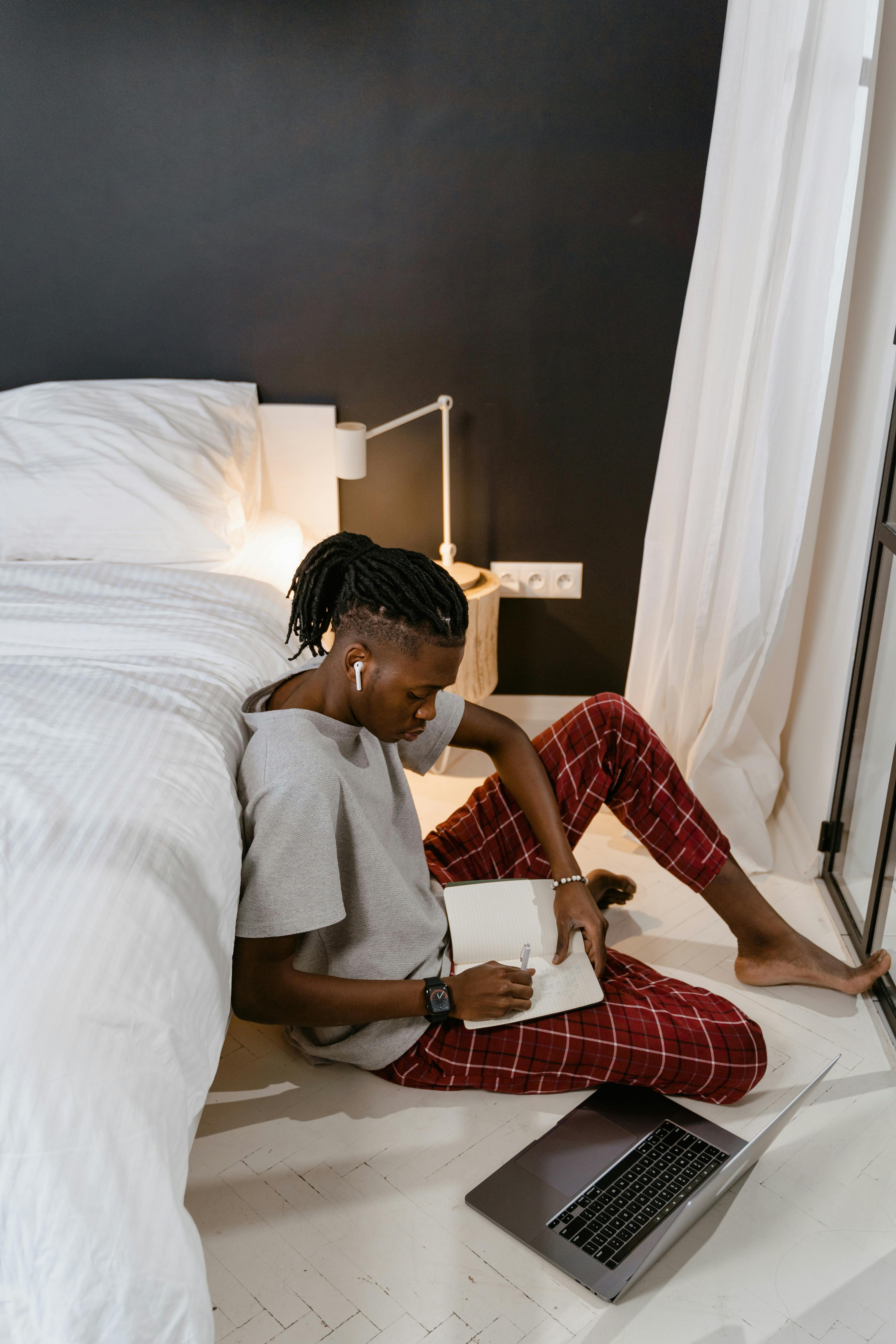 woman in gray shirt sitting on bed