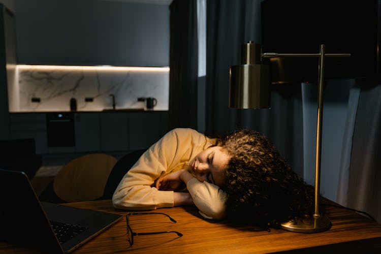 A Woman Fall Asleep On A Desk