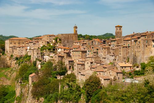 Free Enchanting view of Pitigliano's medieval architecture under a clear summer sky. Stock Photo