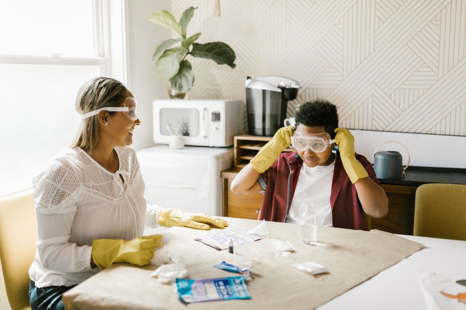 A mother and son engage in a fun science experiment at home, fostering creativity and learning.