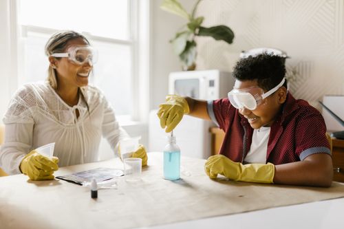 Free A mother and son engaged in a fun and educational science experiment at home, fostering quality family time. Stock Photo