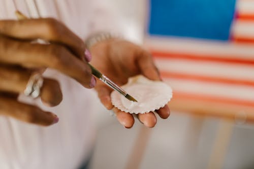 A Person Painting a Sea Shell