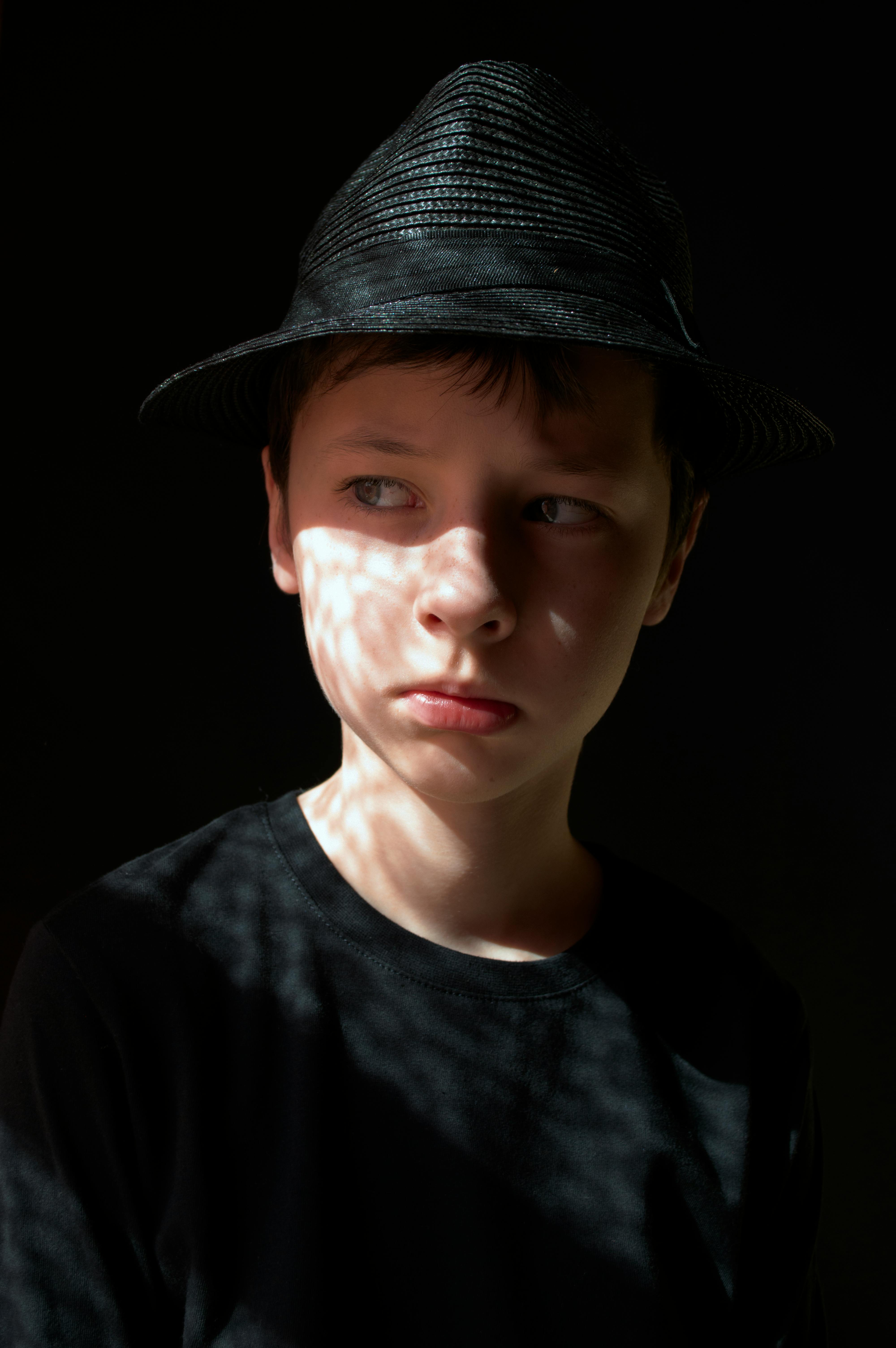 thoughtful man in hat in murk room