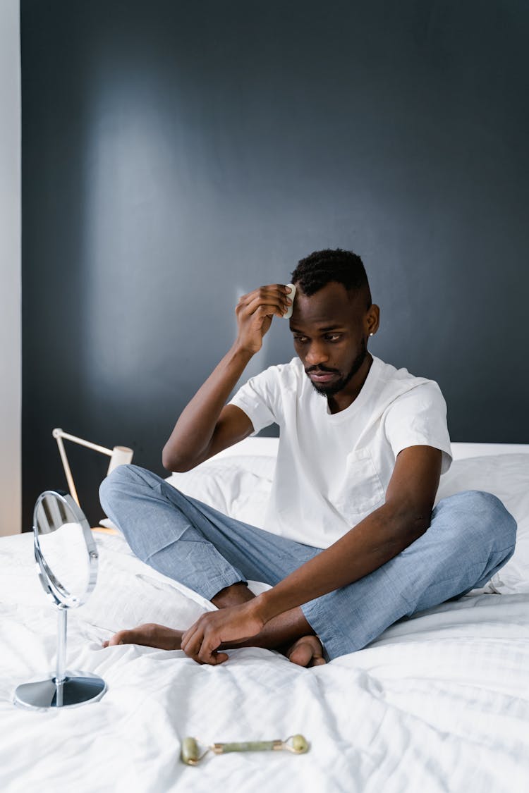 Man In White Crew Neck T-shirt Sitting On Bed