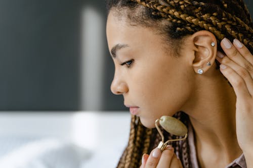 Woman using Jade Facial Roller 