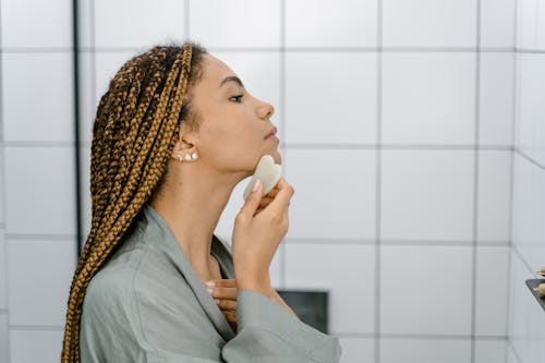 Woman using Gua Sha on her Face