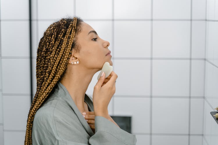 Woman Using Gua Sha On Her Face