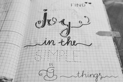 Black and white image of a handwritten inspirational quote on a notebook page.
